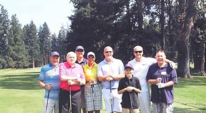 Pictured (left to right): Steve Calkins, Ron Hartman, John Spencer, Nedra and Randy Miller, Riley (Mike Hagan’s grandson), Josh St Clair, and Mike Hagan